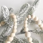 Wood bead garland with flocked tree branch
