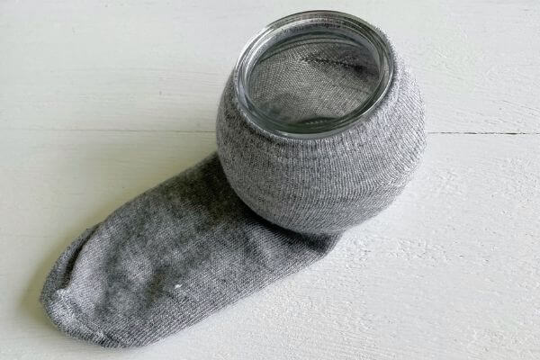 Place sock on jar for gnome body