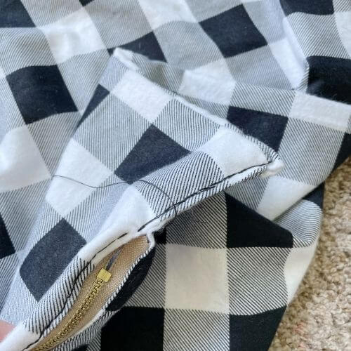 Sew remaining fabric at ends of zipper