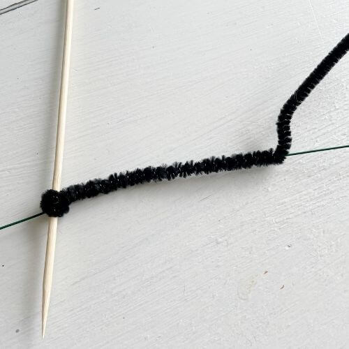 Wrap black pipe cleaner around wire for legs