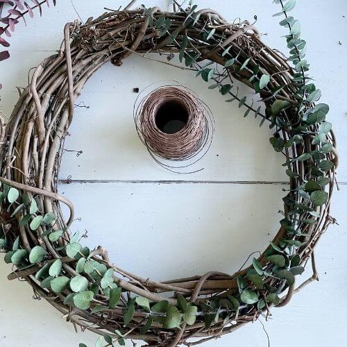 Weave eucalyptus into wreath and secure with wire