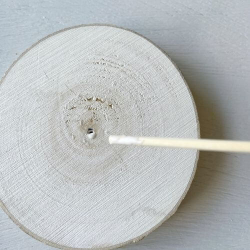 Place skewer into wood slice securing with glue