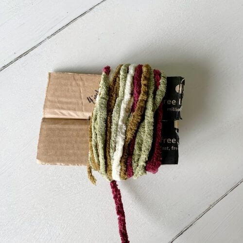 Wrap yarn around cardboard to make pom-pom