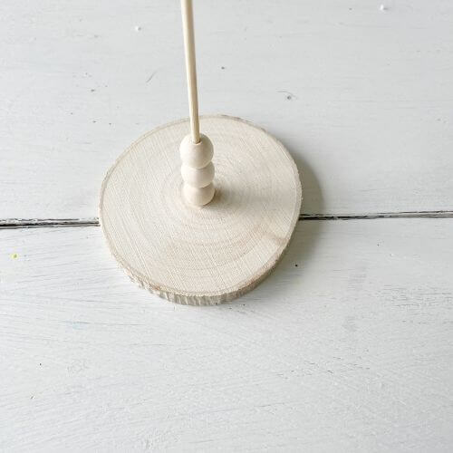 Place three wood beads on skewer, secure with glue