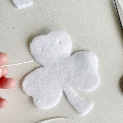 Cut small holes in felt at top for string