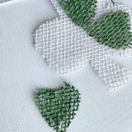 Or use hot glue to adhere green shapes to each cloverleaf
