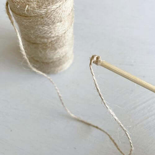 Place mod podge on bottom of skewer and begin wrapping twine