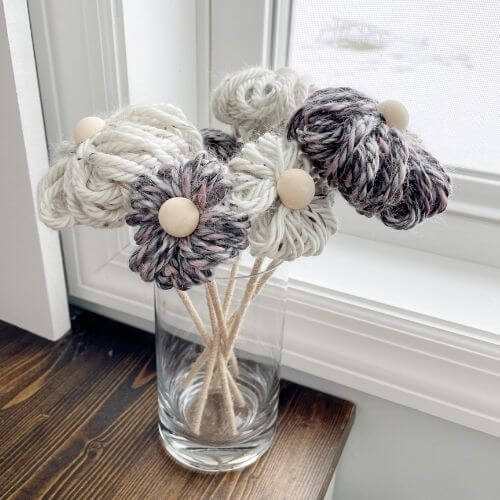 Neutral yarn flowers displayed in vase