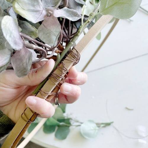 Wrap floral wire around eucalyptus stem to secure it