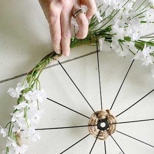 Arrange the baby's breath stems toward the bottom of the wreath form