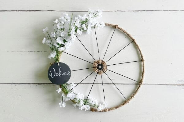 Finished bike wheel wreath with supplies from Dollar Tree