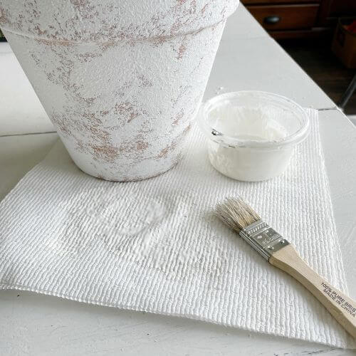 Apply baking soda/paint to clay pot with chippy brush