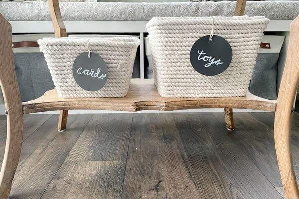 Two DIY Dollar Tree Rope Baskets on table