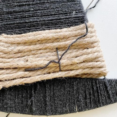 Pictured is yarn weaved through and tied in back to create buckle