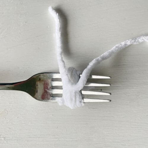 Wrap your yarn around a fork 20 times and tie off.