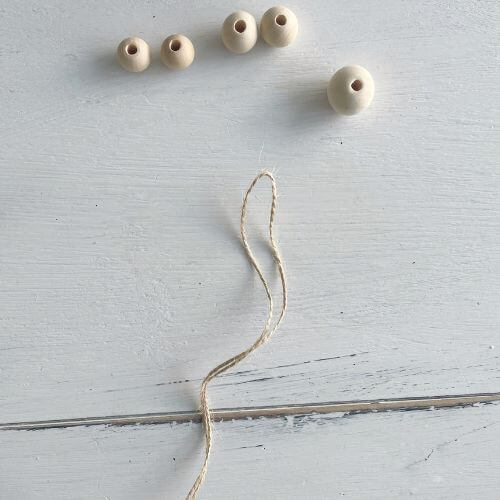 Five wood beads and jute twine string 