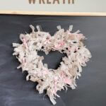 Burlap heart wreath hanging on chalkboard