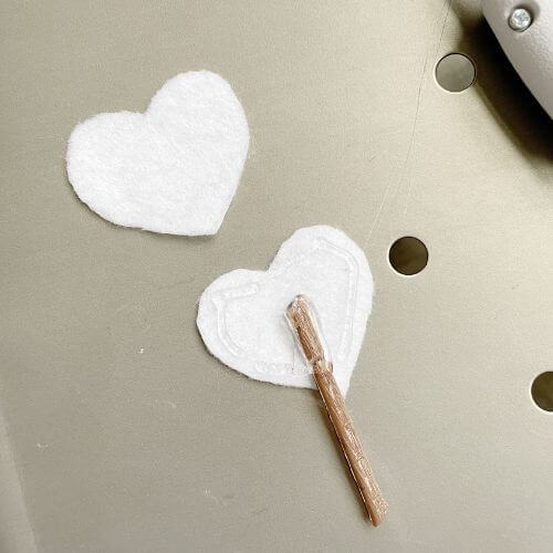Place stem between two felt hearts securing with hot glue. Leave portion of stem out to poke into the wreath.