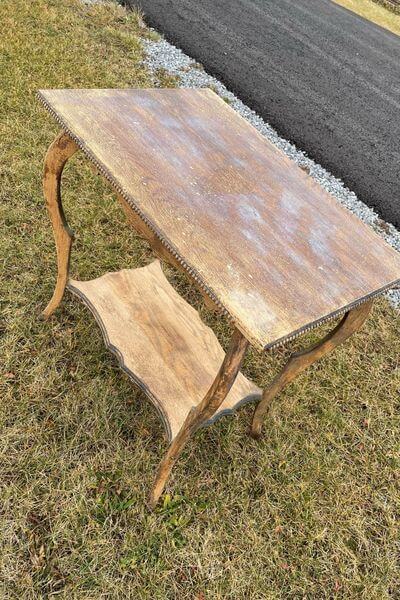 Small table that has dried but has white residue on the top. 