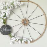 Bicycle wheel wreath with baby's breath, jute rope and welcome tag.