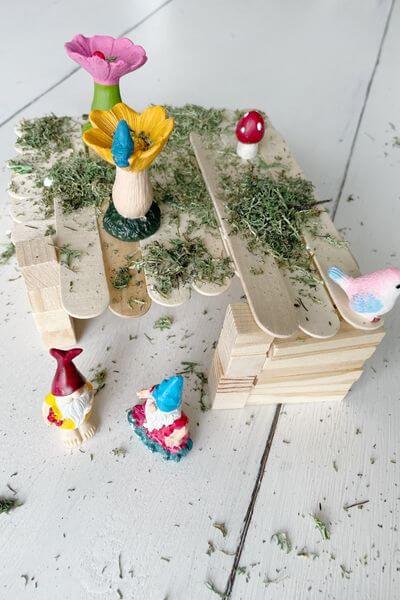 Glue reindeer moss in various places on the gnome home using Elmer's Glue. 