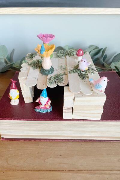 Finished gnome house using Dollar Tree wood blocks, Jenga pieces, craft sticks and figurines.
