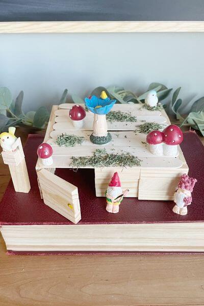 Finished gnome house using Dollar Tree wood blocks, Jenga pieces, craft sticks and figurines.
