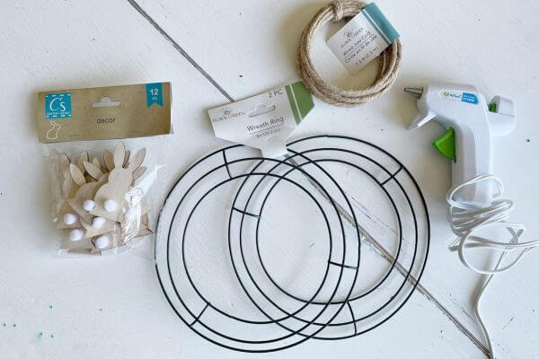 Supplies including jute wire, 8-inch wreath forms, bunny wood cut-outs and glue gun.