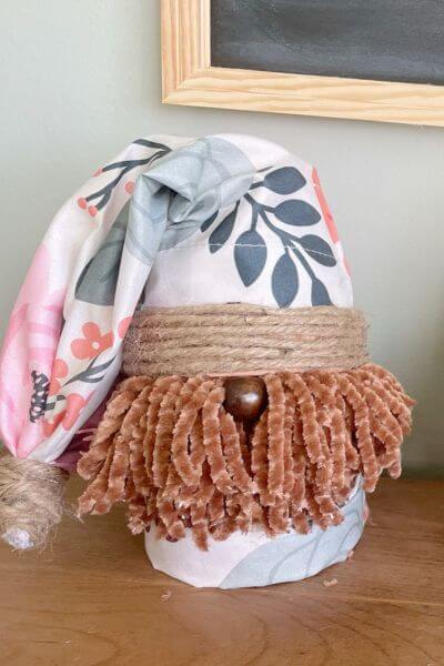 DIY terra cotta pot gnome with floral pillowcase. 