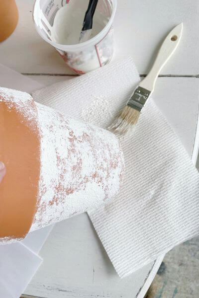 Use a small chippy brush to apply the baking soda and paint mixture. 