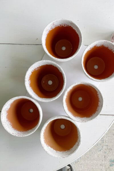 Six pots painted with mixture of baking soda and white paint.