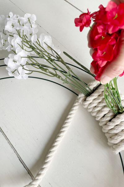 Wrap the rope under the white baby's breath flower stems