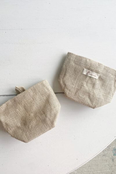 Two burlap wall baskets, one with the tag removed.