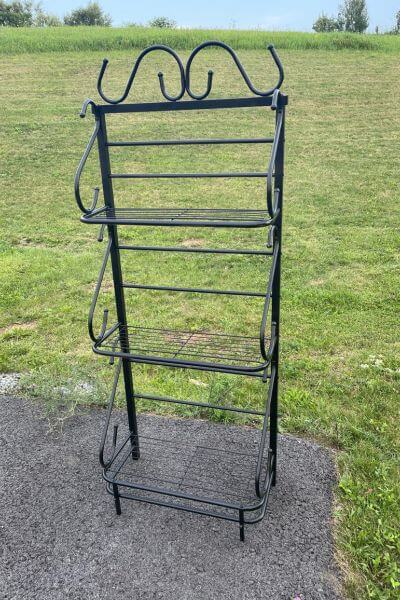 Metal shelf spray painted black. 