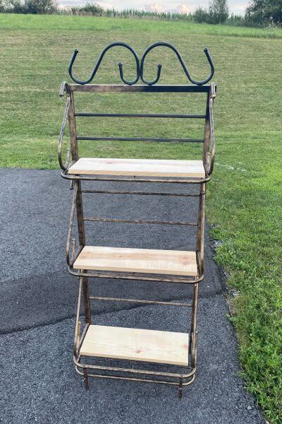 Metal shelf DIY with a board on each of the three shelves.