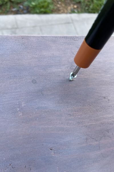 Use a screwdriver to place the screws into each spot. 