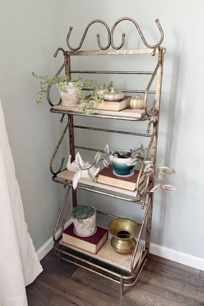 Completed wire 3-tiered shelf in the corner of a room.