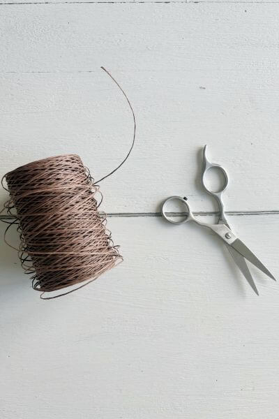 Supplies including brown floral wire and scissors.