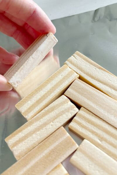 Apply wood glue to the side of the first Jenga block.