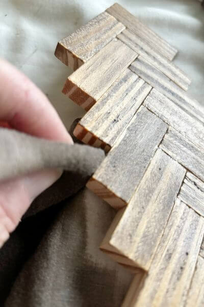 Getting in the branch nooks with a folded cotton cloth with stain applied. 