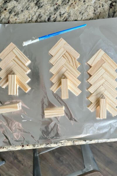 Three Jenga block trees on tin foil glued together with wood glue. 