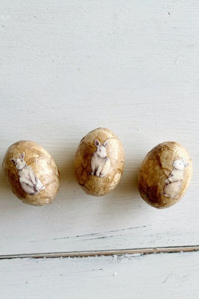 Three decoupaged eggs with vintage rabbit printables applied.