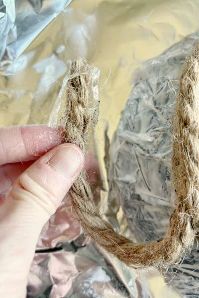 Snip plastic off the end of the jute rope before applying it the the bowl. 