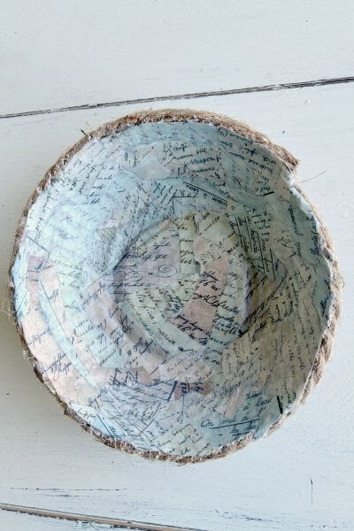 Inside of rope bowl completely covered in paper pieces and sealed with mod podge.