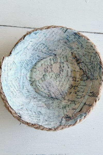 Rope bowl with vintage paper pieces covering the inside. 
