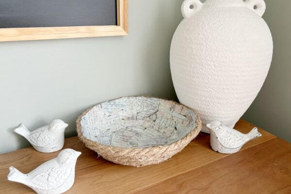 Rope bowl displayed with a white vase and three white birds.