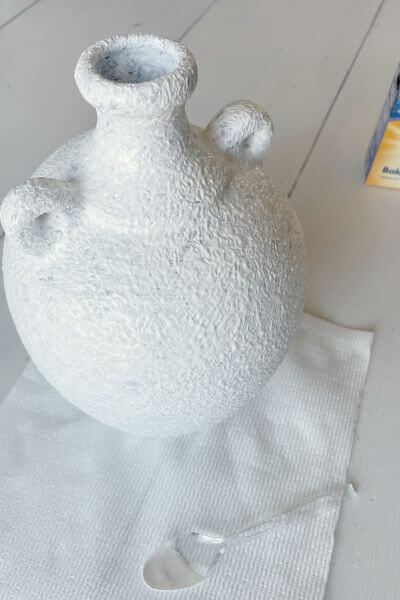 Vase painted with white paint and baking soda. 