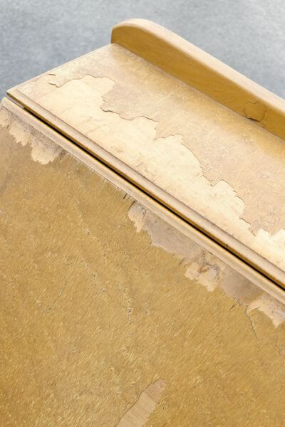 Top of thrifted secretary's desk with cracked veneer. 
