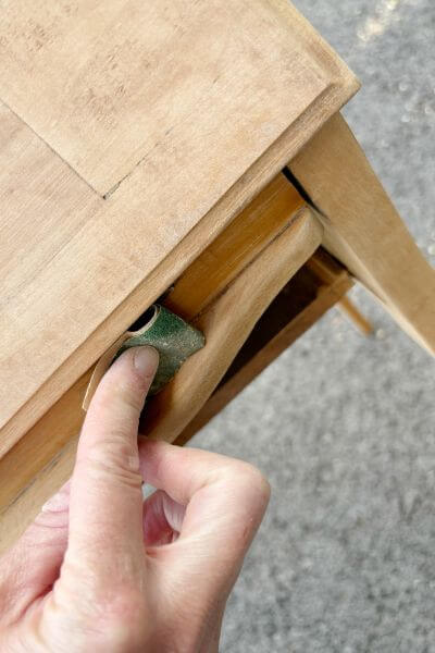 Sanding the smaller hard to reach areas with a folded-up piece of sandpaper. 