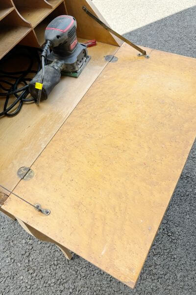 Inside of desk has veneer where the front of the desk opens. 